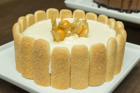 Delicious vanilla pie with a exotic fruit on the top and crackers on the sides. Tasty home made...