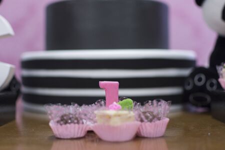 Girl birthday party decoration detail Panda theme. Wonderful sweets, cupcakes, cake, boxes and...