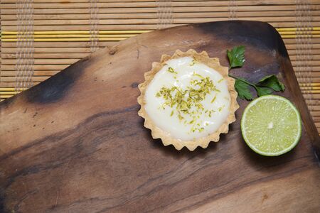 Top view of Tartlet with lemon cream and citrus chips on the old wooden table, Copy space. Selective focus.の写真素材