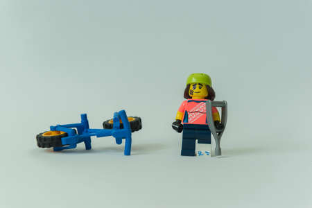 Florianopolis - Brazil, February 2, 2020: Injured cyclist minifigure with broken leg. Biker with...