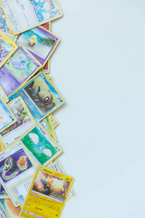 Florianopolis - Brazil, July 12, 2019: Pokemon cards distributed on the white table. Brazilian youth perform battles using these collectible cardsのeditorial素材