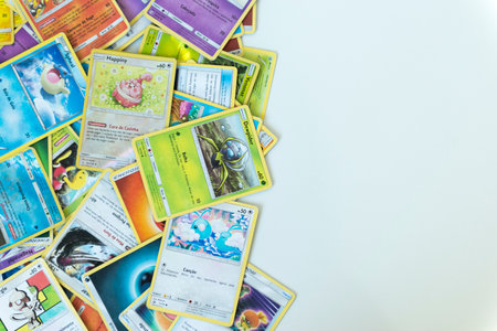 Florianopolis - Brazil, July 12, 2019: Pokemon cards distributed on the white table. Brazilian youth perform battles using these collectible cardsのeditorial素材