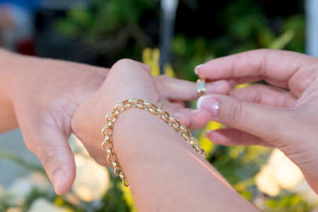 hands together exchanging wedding rings - Grooms hands joined using wedding rings - golden wedding...