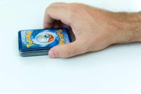 Florianopolis, Brazil, July 13, 2019: close-up of a man hand holding Pokemon Cards. Brazilian youths perform battles using these collectibles cards.のeditorial素材