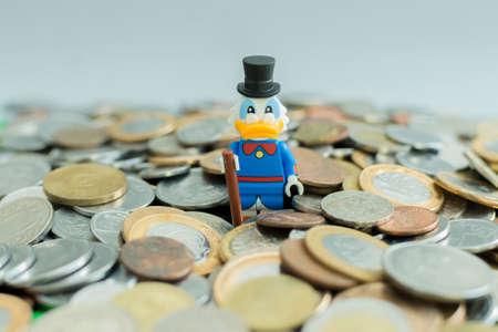 FlorianÃ³polis - Brazil, July 9, 2019: Minifigure of Scrooge McDuck surrounded by many coins. Lego minifigures are manufactured by The Lego Group.のeditorial素材