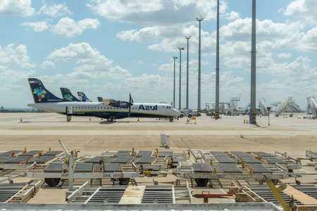 Campinas, Viracopos Airport, Brazil - March 24, 2022: side view of several ATR-72 model turboprop passenger planes lined up side by side parked at the airport in a sunny day. Capacity of 72 passengersのeditorial素材