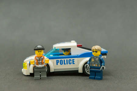 Bauru, Brazil. September 15, 2019. Lego minifigure of police officer driving police car. Police patrol is important for the found for offenders. Lego minifigures are manufactured by The Lego Group.のeditorial素材
