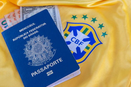 Bauru, Brazil - 11.01.23: Brazilian Football Confederation emblem on football jersey. Soccer players sale and trading concept. Passport and money from fans or players on the Brazilian team t-shirtのeditorial素材
