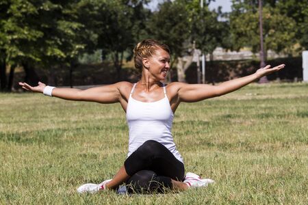 Beautiful woman smiling and doing yoga の写真素材