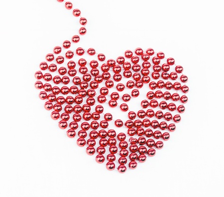 Red heart made of pearls on white backgroundの写真素材