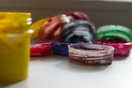 jars of acrylic paint on a window sillの写真素材