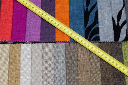 Samples of furniture fabrics and measuring tape