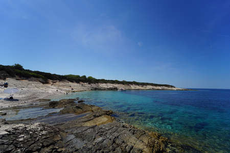 Beach on the island of Proizd, near Vela Luka in Dalmatia, Croatia. The islet of Proizd is known for its crystal clear sea and beautiful beaches. This is a popular tourist destination.の写真素材