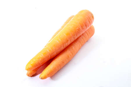 3 pieces of fresh carrot isolated on a white back groundの写真素材