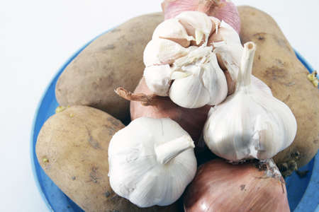 Unions, garlic and potatoes on isolated white backgroundの写真素材