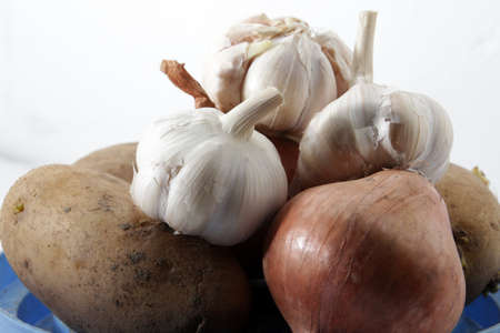 Unions, garlic and potatoes on isolated white backgroundの写真素材