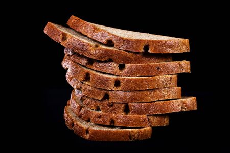 Several pieces of bread on blacj background