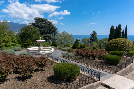 fountain in the garden in front of the white Livadia Palace in Yalta Crimea on a beautiful background with the sea and cloudsのeditorial素材