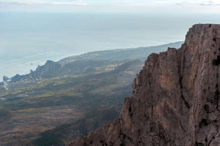a steep high cliff against the sea of a recedingの写真素材