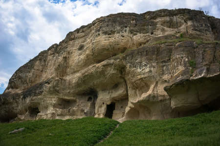 Cave city Tepe-Kerman in the Crimea. The ancient city among the rocks on the background of a mountain rangeの写真素材