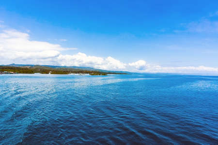 blue sea with blue sky and white cloudsの写真素材