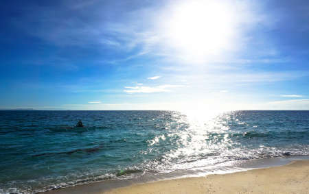 fisherman at sea, catch fish in the bright sunの写真素材