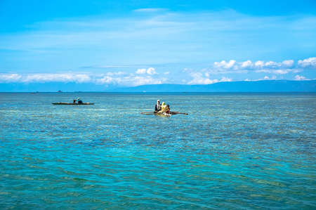 Philippine aboriginal fishermen catch fish in the blue seaの写真素材
