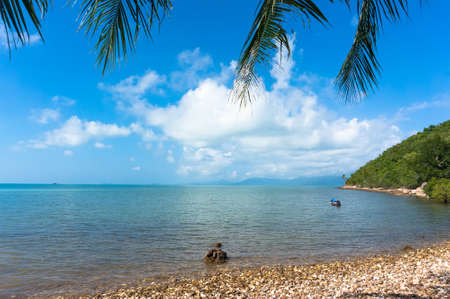View of the blue sea under palm trees on the beach in Koh Samui Thailandの写真素材