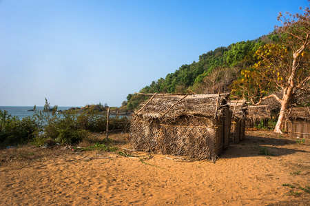 Thatched bungalows on the beach. Cheap house in India.の写真素材