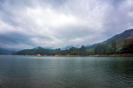 Beautiful landscape with mountain lake amid high mountains with tea plantations and cloud sky. Munnar Kerala India.の写真素材