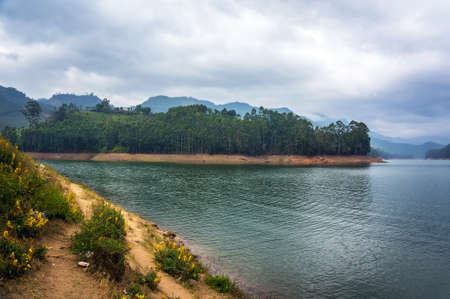 Mountain lake Kundale with overcast sky in Munnar, Kerala, Indiaの写真素材
