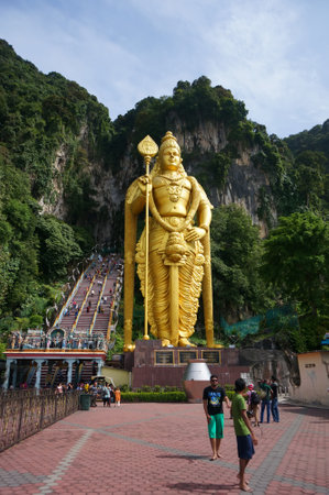 Crowds of tourists flock to A giant gold statue of Lord Muruga stands outside the Batu Caves Photo taken, 2017 in Kuala Lumpur, Malaysiaのeditorial素材