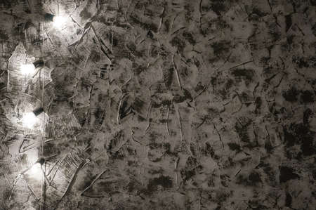 Lamp old background wall grunge. Garland on the old wall. Chipped plaster in the loftの写真素材