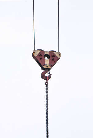 old hook from a tower crane on an isolated white backgroundの写真素材
