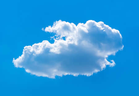 Lonely white Cumulus cloud on a solid blue background of the heavensの写真素材