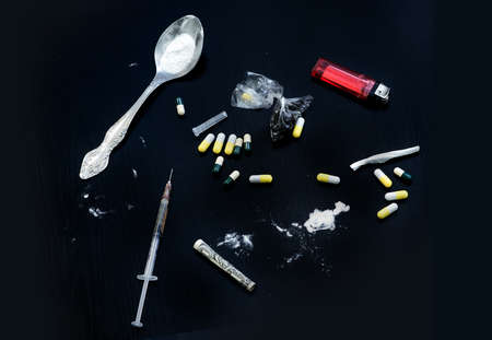 Drug syringe and cooked heroin. Various substances causing dependence. Problems with drugs concept. Top viewの写真素材