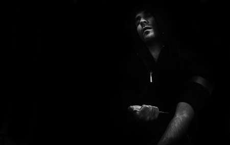 Conceptual abstract photo addicted man who makes a shot dose of heroin into a vein. Black-and-white...