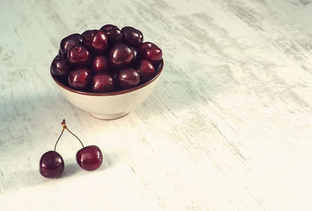 sour cherries dish on white wooden table, directly aboveの写真素材