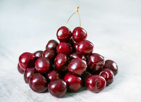 cherries in bowl and near on white backgroundの写真素材