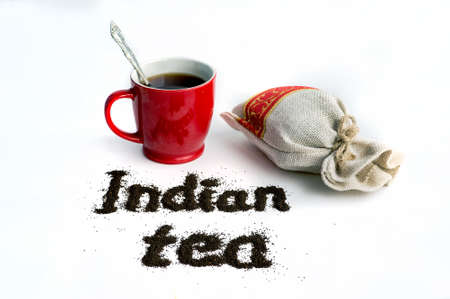 inscription Indian tea on a isolated white background next to the mug and packaging of granular loose black teaの写真素材