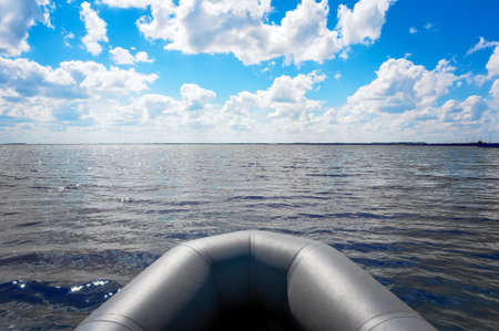 Inflatable boat on the wide river at morning. bow of the boatの写真素材