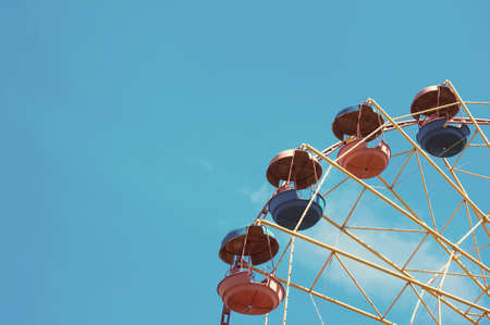 Wheel display, on the background of blue sky. Summer attraction at Luna Park.の写真素材