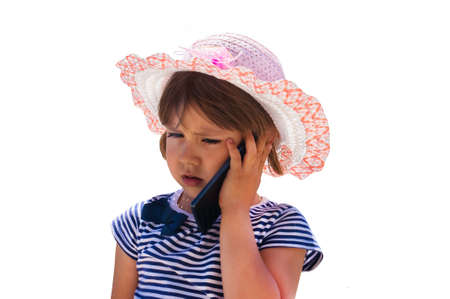 Cute little girl speaking on the cell phone. isolated on a white backgroundの写真素材
