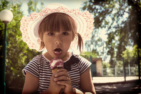 The child eats ice cream. retro toning photoの写真素材