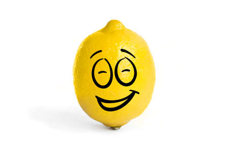yellow fresh lemon isolated on the white background. A smiley face in the shape of a lemon. Laughing lemonの写真素材