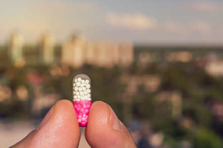 Tablet in the hands of a person on the background of the urban landscape.