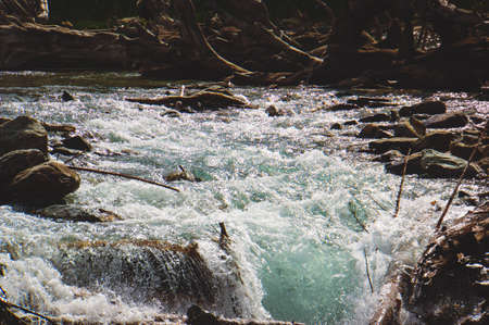 Stormy mountain river. pure melt-water in the water flow in the riverの写真素材