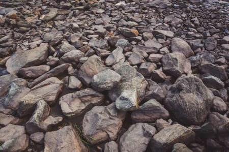 grey smooth stones in the river in the background.の写真素材