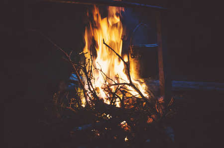Bonfire night. The food is prepared in a cauldron on an open fire in the woodsの写真素材