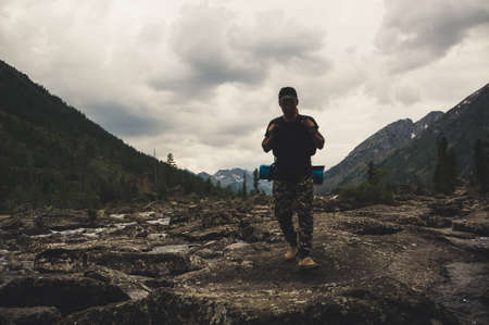 Lake with rocky ridge. Beautiful landscape. The tourist goes over the rocks on the shore of the lake. Altay Russia.の写真素材